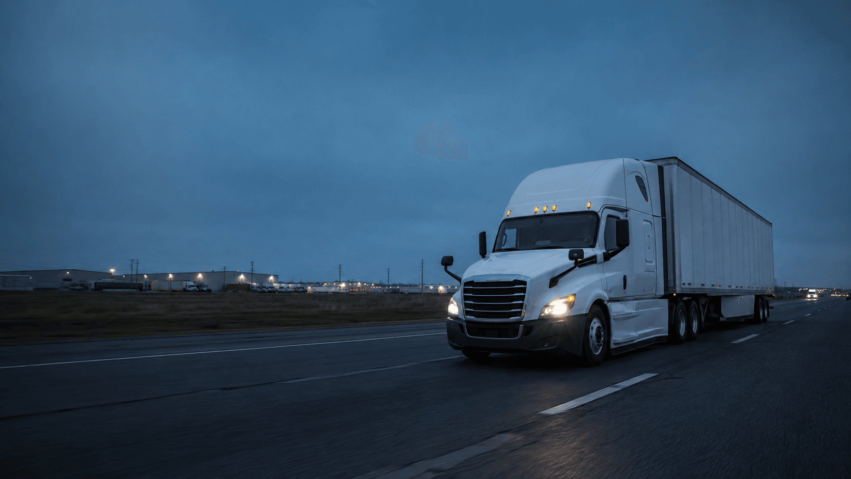 Commercial freight truck moving along highway corridor